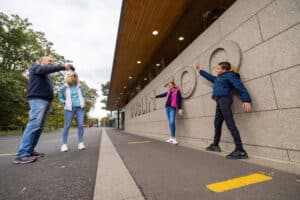 View of family taking pictures of their kids at Dublin Zoo sign