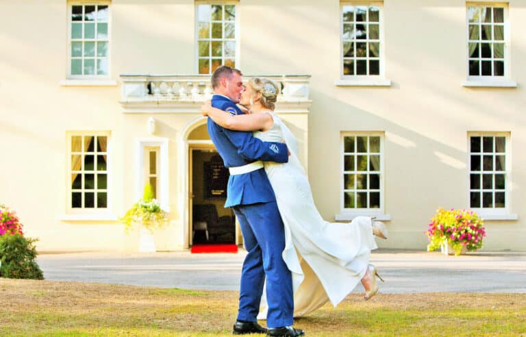 Wedding Couple Kissing Infront Of Roganstown House & Country Club