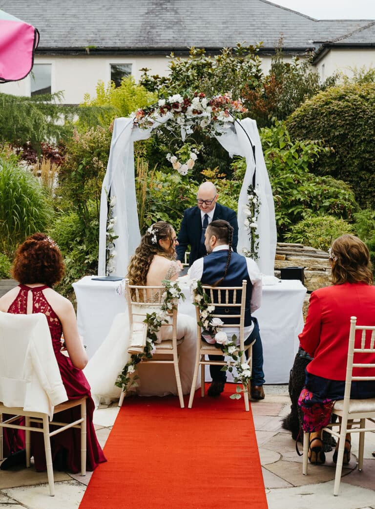Guests attending an outdoor wedding ceremony at Roganstown